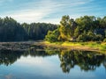 Beautiful old pond in early autumn. Old wooden village on the shore of a picturesque Oredezh River. Rozhdestveno village, near the