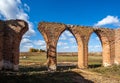 Beautiful old ruined castle of red bricks with arches at autumn on green grass background Royalty Free Stock Photo