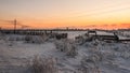 Old rustic fence covered with snow and hoarfrost evening sunset winter landscape cattle corral