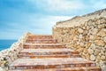 Beautiful old steps leading up to the hill. The road in the form of stairs leads to the sea. Ancient masonry in the resort town Royalty Free Stock Photo