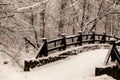 Beautiful old stone bridge of winter forest in the snow at sunset frosty days. Trees covered in frost and snow. Royalty Free Stock Photo