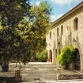 Beautiful old stone provencal chateau vineyard in sunny summer day with stone yard and garden around in heart of Provence.