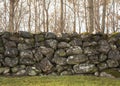 Beautiful old stone wall in front of autumn/winter forest Royalty Free Stock Photo