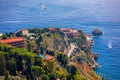 Beautiful old town of Taormina with small streets, flowers. Architecture with archs and old pavement in Taormina. Colorful narrow