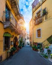 Beautiful old town of Taormina with small streets, flowers. Architecture with archs and old pavement in Taormina. Colorful narrow