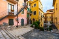 Beautiful old town of Taormina with small streets, flowers. Architecture with archs and old pavement in Taormina. Colorful narrow