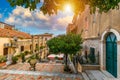 Beautiful old town of Taormina with small streets, flowers. Architecture with archs and old pavement in Taormina. Colorful narrow