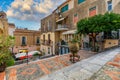 Beautiful old town of Taormina with small streets, flowers. Architecture with archs and old pavement in Taormina. Colorful narrow