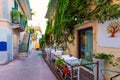 Beautiful old town of Taormina with small streets, flowers. Architecture with archs and old pavement in Taormina. Colorful narrow