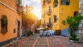 Beautiful old town of Taormina with small streets, flowers. Architecture with archs and old pavement in Taormina. Colorful narrow