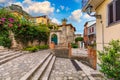 Beautiful old town of Taormina with small streets, flowers. Architecture with archs and old pavement in Taormina. Colorful narrow Royalty Free Stock Photo