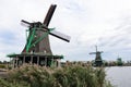 Traditional Old Green Windmills along the Zaan River in Zaanse Schans Netherlands