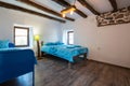 Beautiful old vintage country house - bedroom interior with wood beam ceiling and blue duvets and sheets Royalty Free Stock Photo