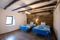 Beautiful old vintage country house - bedroom interior with wood beam ceiling and blue duvets and sheets Royalty Free Stock Photo