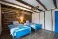 Beautiful old vintage country house - bedroom interior with wood beam ceiling and blue duvets and sheets Royalty Free Stock Photo