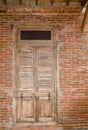 Old vintage wooden door on red brick wall. Royalty Free Stock Photo