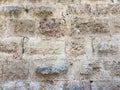 Beautiful old wall made of different bricks. Rough masonry with cement Royalty Free Stock Photo