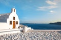 Beautiful old white church against the blue sky and blue Aegean sea. Oia, Santorini, Greece, Europe. Classic white Greek