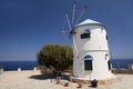 Beautiful old windmill on Greece island on the sea beach