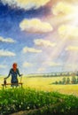 Beautiful old woman grandmother sits with cat on bench and enjoys flowering summer field and blue sky with large clouds