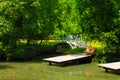 Beautiful old wooden bridge across the river Old wooden bridge across the pond, summer garden design Royalty Free Stock Photo