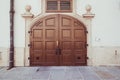 Beautiful old wooden brown door with panels in a medieval style Royalty Free Stock Photo