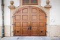 Beautiful old wooden brown door with panels in a medieval style Royalty Free Stock Photo