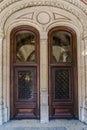 Wooden brown Front Door of a Luxurious house. Doors with glass and forged window grille Royalty Free Stock Photo