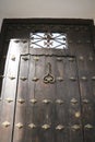 Old wooden door with wrought iron details Royalty Free Stock Photo