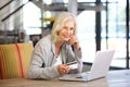 Beautiful older woman with laptop computer and credit card Royalty Free Stock Photo