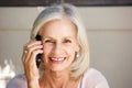 Beautiful older woman talking on cell phone outside Royalty Free Stock Photo
