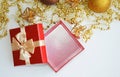 An open red gift box and golden beads and a Christmas ball. background for decoration for the winter holidays Christmas and New Ye Royalty Free Stock Photo