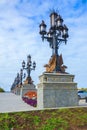 Beautiful openwork lamppost decorated with sculptures of a griffin on the square in the tourist complex Garibaldi Castle. The vill