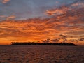 Beautiful orange blazing sunset view blue calm sea tropical with blue clouds over sky