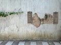 Beautiful orange brick with cracks old style on cement walls with green leave, abstract art background and vintage wallpaper