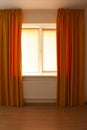 Beautiful orange curtains and roller blinds in an apartment Royalty Free Stock Photo