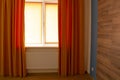 Beautiful orange curtains and roller blinds in an apartment Royalty Free Stock Photo