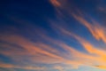 Beautiful orange feather clouds on a blue sky at sunset, magical background, autumn, spring, summer. Weather forecast Royalty Free Stock Photo