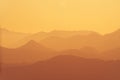 Beautiful orange layers of hills and mountains during sunset Royalty Free Stock Photo