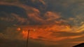 Beautiful orange and multi color clouds and a street light lamp at dusk Royalty Free Stock Photo