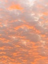 Beautiful orange and pink sky with scattered clouds at sunset. Pastel tones Royalty Free Stock Photo