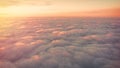Beautiful orange and pink sunrise over the clouds, view from the plane Royalty Free Stock Photo