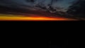 Beautiful orange and red sunset view with cumulus rain clouds from the drone view. Aerial landscape Royalty Free Stock Photo