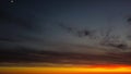 Beautiful orange and red sunset view with cumulus rain clouds and moon from drone view. Aerial landscape Royalty Free Stock Photo