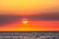 Beautiful orange-shaded sunset sky over the blue seascape