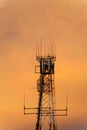 Beautiful orange sky behind the silhouette of a radio communications tower Royalty Free Stock Photo