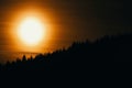 Beautiful orange sunset behind dark forest Royalty Free Stock Photo