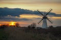 Beautiful orange sunset over Thurne Dyke Drainage Mill in The Broads, Norfolk Royalty Free Stock Photo