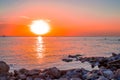 Beautiful orange sunset over the sea with rocky coast. Sea evening landscape Royalty Free Stock Photo