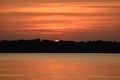 Beautiful orange sunset reflected on the calm water of the lake